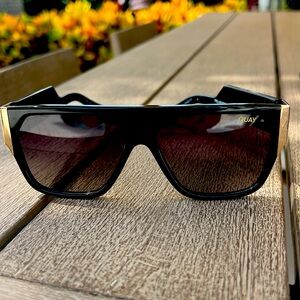 Quay black and gold polarized sunglasses with case.